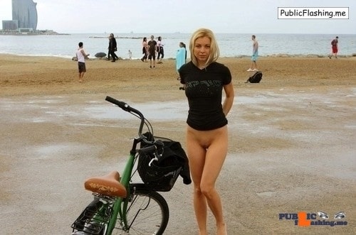 Amateur: Bottomless blonde and a bicycle on the beach 24 years old blond girl is posing bottomless next to the bicycle on a public beach. She is wearing no panties or bikini bottoms so her shaved pussy is exposed totally to the...