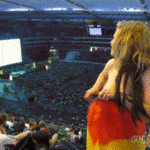 Nude blonde with German flag flashing nude in sports arena