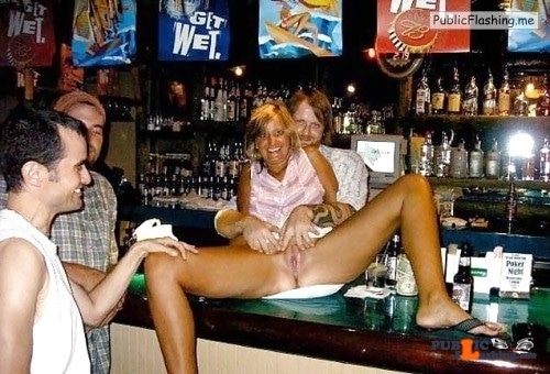 Mature blonde surrounded with men is spreading legs on bar Public Flashing