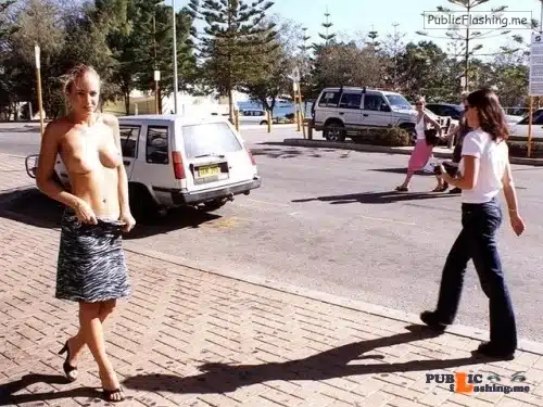 sex in public - Topless Tease on Public Sidewalk: Exhibitionist’s Bold Display A topless woman stands defiantly on a public sidewalk, her small, perky tits exposed, nipples erect. Behind her, a white SUV and a brick sidewalk lead t... - Public Flashing Photo Feed