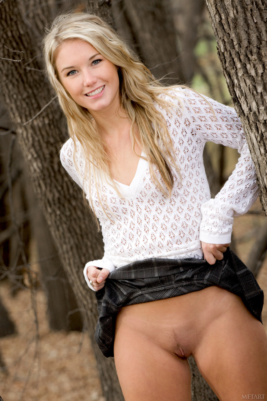 No panties: Blonde Flashes Pussy in Public Woods A daring blonde goes completely pantiesless, flashing her pussy in the public woods. Bold, playful, and adventurous, she enjoys the thrill of exhibitionist fun outdoors.